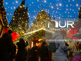 Visitors check the stalls selling Christmas decorations at Cologne Christmas in front of Dam Cathedral in Cologne, Germany, on November 18,...