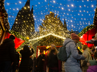 Visitors check the stalls selling Christmas decorations at Cologne Christmas in front of Dam Cathedral in Cologne, Germany, on November 18,...