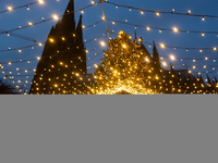 Visitors check the stalls selling Christmas decorations at Cologne Christmas in front of Dam Cathedral in Cologne, Germany, on November 18,...