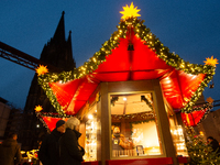 Visitors check the stalls selling Christmas decorations at Cologne Christmas in front of Dam Cathedral in Cologne, Germany, on November 18,...