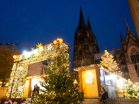 Visitors check the stalls selling Christmas decorations at Cologne Christmas in front of Dam Cathedral in Cologne, Germany, on November 18,...