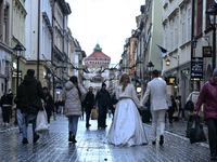 KRAKOW, POLAND - NOVEMBER 18:   
A newlywed couple strolls along Floriańska Street on a cold, wintery Monday afternoon, seen on November 17,...