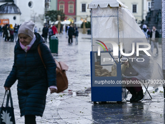 KRAKOW, POLAND - NOVEMBER 18:   
A vendor of traditional Krakow obwarzanki (a braided, ring-shaped bread boiled and sprinkled with salt, ses...