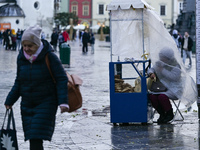 KRAKOW, POLAND - NOVEMBER 18:   
A vendor of traditional Krakow obwarzanki (a braided, ring-shaped bread boiled and sprinkled with salt, ses...