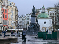 KRAKOW, POLAND - NOVEMBER 18:   
Partial view of a quiet and nearly empty Krakow's UNESCO-listed Market Square on a rainy and cold November...