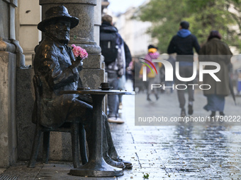 KRAKOW, POLAND - NOVEMBER 18:   
View of Piotr Skrzynecki's statue in Krakow's UNESCO-listed Market Square on a rainy and cold November afte...