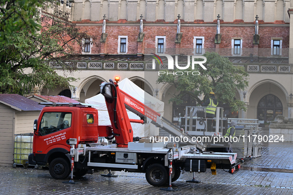 KRAKOW, POLAND - NOVEMBER 18:   
Municipal staff begin decorating trees around the UNESCO-listed Krakow Main Market Square with Christmas li...