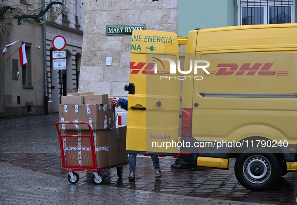 KRAKOW, POLAND - NOVEMBER 18:   
DHL delivery van in Krakow's Small Square, seen on November 17, 2024 in Krakow, Poland. 