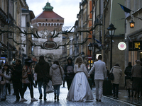 KRAKOW, POLAND - NOVEMBER 18:   
A newlywed couple strolls along Floriańska Street on a cold, wintery Monday afternoon, seen on November 17,...