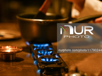 KRAKOW, POLAND - NOVEMBER 18:   
Staff member melting chocolate over natural gas burners on a stove in a Krakow cafe, showcasing the role of...