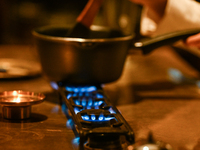 KRAKOW, POLAND - NOVEMBER 18:   
Staff member melting chocolate over natural gas burners on a stove in a Krakow cafe, showcasing the role of...