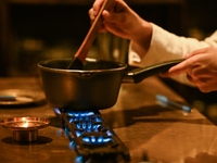 KRAKOW, POLAND - NOVEMBER 18:   
Staff member melting chocolate over natural gas burners on a stove in a Krakow cafe, showcasing the role of...