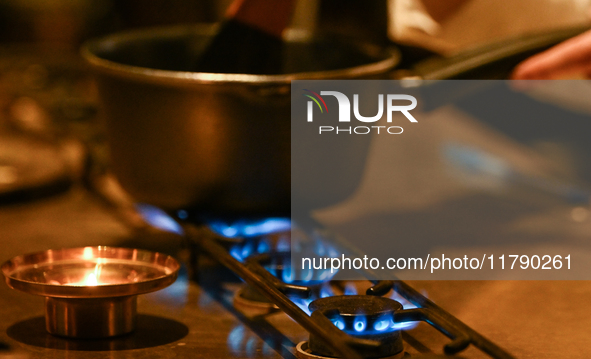 KRAKOW, POLAND - NOVEMBER 18:   
Staff member melting chocolate over natural gas burners on a stove in a Krakow cafe, showcasing the role of...