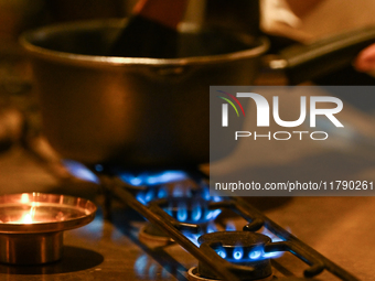 KRAKOW, POLAND - NOVEMBER 18:   
Staff member melting chocolate over natural gas burners on a stove in a Krakow cafe, showcasing the role of...