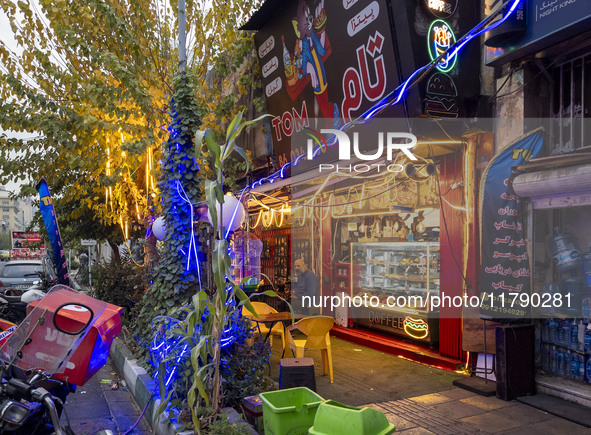 An Iranian man sits outside a small fast-food restaurant in downtown Tehran, Iran, on November 17, 2024. 