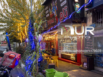 An Iranian man sits outside a small fast-food restaurant in downtown Tehran, Iran, on November 17, 2024. (