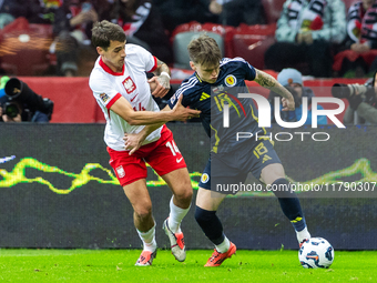 Jakub Kiwior (L) and Ben Doak are playing  during the  UEFA Nations League 2024 League A Group A1 match between Poland and Scotland, at the...