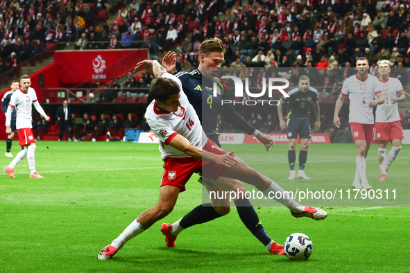 Jakub Kiwior and Scott McTominay during UEFA Nations League match Poland - Scotland at National Stadium in Warsaw, Poland on November 18, 20...