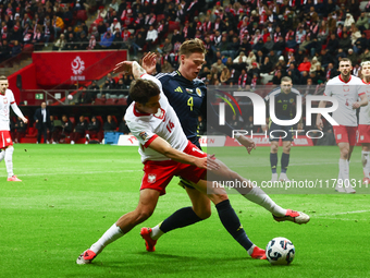 Jakub Kiwior and Scott McTominay during UEFA Nations League match Poland - Scotland at National Stadium in Warsaw, Poland on November 18, 20...