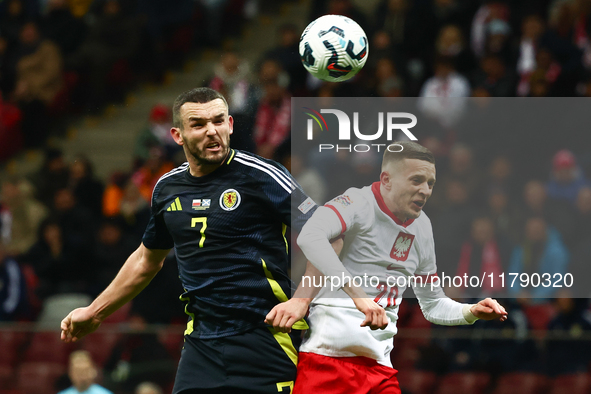 John McGinn and Sebastian Szymanski during UEFA Nations League match Poland - Scotland at National Stadium in Warsaw, Poland on November 18,...