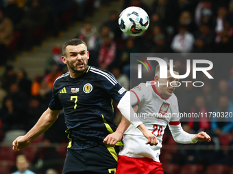 John McGinn and Sebastian Szymanski during UEFA Nations League match Poland - Scotland at National Stadium in Warsaw, Poland on November 18,...