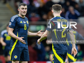 John Souttar (L) and  Anthony Ralston talk during the  UEFA Nations League 2024 League A Group A1 match between Poland and Scotland, at the...