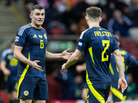 John Souttar (L) and  Anthony Ralston talk during the  UEFA Nations League 2024 League A Group A1 match between Poland and Scotland, at the...