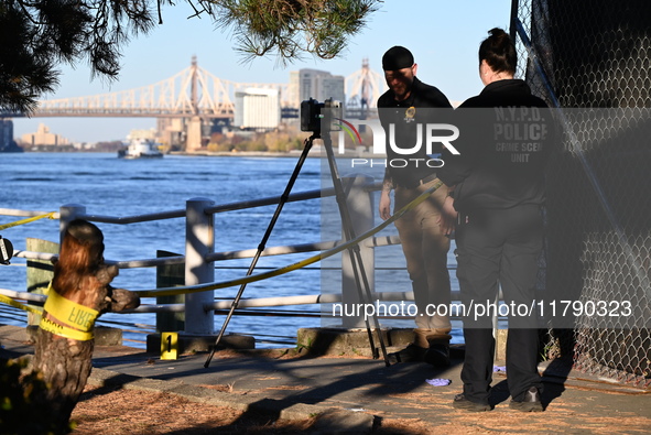 Crime scene investigators with the NYPD collect evidence and guard the scene after a 68-year-old man who is fishing is fatally stabbed multi...