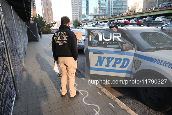 Crime scene investigators with the NYPD collect evidence and guard the scene after a 68-year-old man who is fishing is fatally stabbed multi...