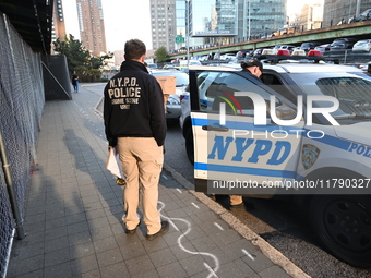 Crime scene investigators with the NYPD collect evidence and guard the scene after a 68-year-old man who is fishing is fatally stabbed multi...