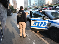 Crime scene investigators with the NYPD collect evidence and guard the scene after a 68-year-old man who is fishing is fatally stabbed multi...