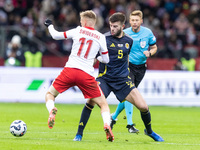 Karol Swiderski , Grant Hanley  during UEFA Nations League match Poland vs Scotland in Warsaw Poland on 18 November 2024. (