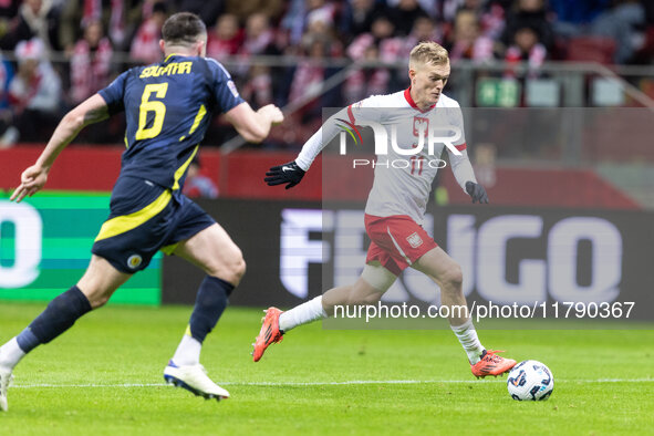 John Souttar , Karol Swiderski  during UEFA Nations League match Poland vs Scotland in Warsaw Poland on 18 November 2024. 