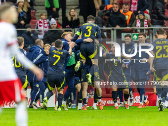 Scottish players celebrate scoring the winning goal during the UEFA Nations League 2024 Group A A1 match between Poland and Scotland at PGE...