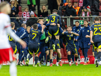 Scottish players celebrate scoring the winning goal during the UEFA Nations League 2024 Group A A1 match between Poland and Scotland at PGE...