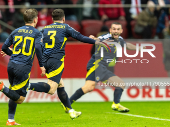 Andy Robertson is celebrating  scoring the winning goal during the UEFA Nations League 2024 Group A A1 match between Poland and Scotland at...