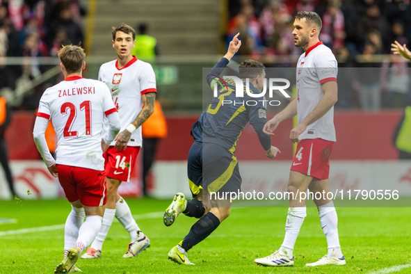 Andy Robertson is celebrating  scoring the winning goal during the UEFA Nations League 2024 Group A A1 match between Poland and Scotland at...