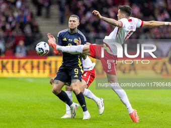 Lyndon Dykes , Jakub Moder  during UEFA Nations League match Poland vs Scotland in Warsaw Poland on 18 November 2024. (