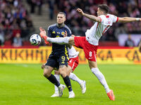 Lyndon Dykes , Jakub Moder  during UEFA Nations League match Poland vs Scotland in Warsaw Poland on 18 November 2024. (