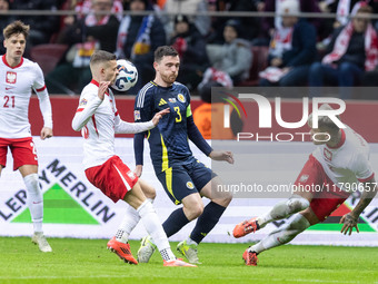 Sebastian Szymanski , Andy Robertson , Kamil Piatkowski  during UEFA Nations League match Poland vs Scotland in Warsaw Poland on 18 November...