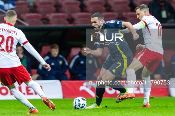 John McGinn (L) and Piotr Zielinski are playing during the  UEFA Nations League 2024 League A Group A1 match between Poland and Scotland, at...