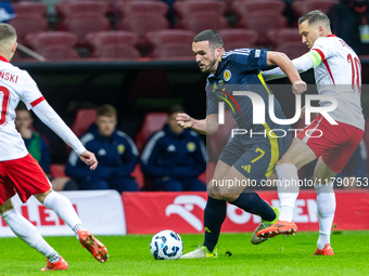 John McGinn (L) and Piotr Zielinski are playing during the  UEFA Nations League 2024 League A Group A1 match between Poland and Scotland, at...