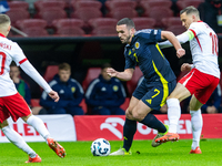 John McGinn (L) and Piotr Zielinski are playing during the  UEFA Nations League 2024 League A Group A1 match between Poland and Scotland, at...