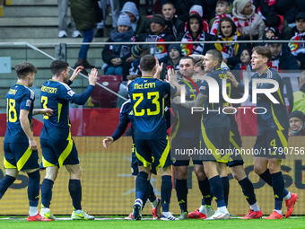 Scottish players celebrate scoring a goal during the  UEFA Nations League 2024 League A Group A1 match between Poland and Scotland, at the...