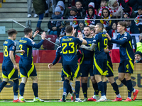 Scottish players celebrate scoring a goal during the  UEFA Nations League 2024 League A Group A1 match between Poland and Scotland, at the...