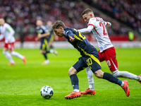 Ryan Gauld (L) and Sebastian Szymanski during the  UEFA Nations League 2024 League A Group A1 match between Poland and Scotland, at the  PGE...