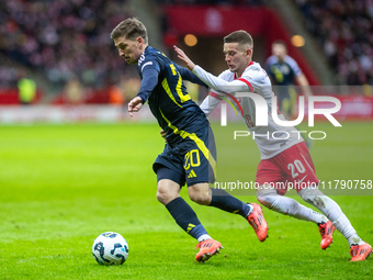 Ryan Gauld (L) and Sebastian Szymanski during the  UEFA Nations League 2024 League A Group A1 match between Poland and Scotland, at the  PGE...