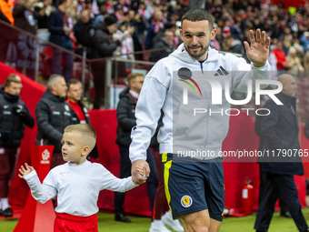 John McGinn walks onto the pitch during the UEFA Nations League 2024 A1 Group A match between Poland and Scotland at PGE Narodowe in Warsaw,...