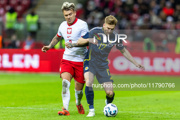 Kamil Piatkowski (L) and Stuart Armstrong during the  UEFA Nations League 2024 League A Group A1 match between Poland and Scotland, at the...