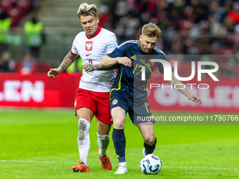 Kamil Piatkowski (L) and Stuart Armstrong during the  UEFA Nations League 2024 League A Group A1 match between Poland and Scotland, at the...